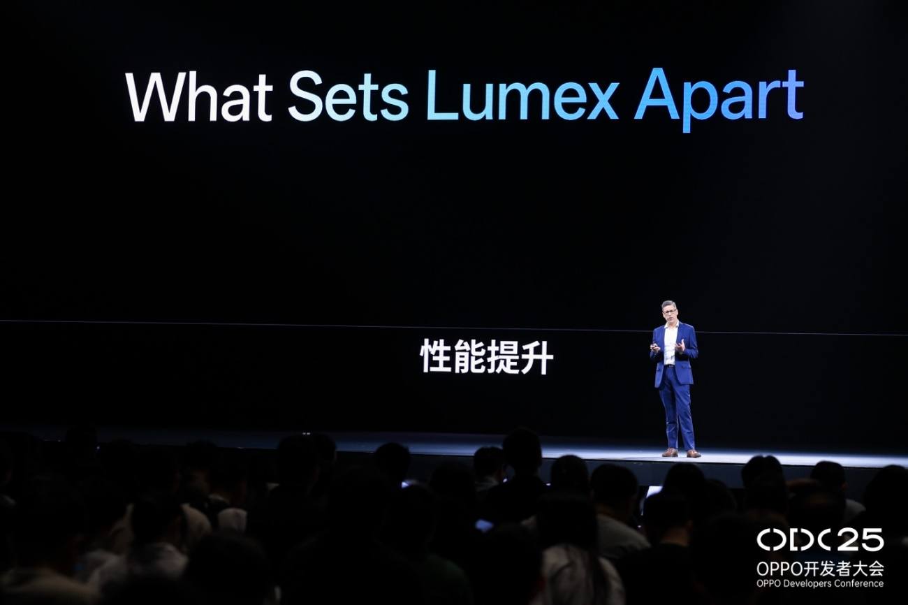 A person in a suit standing on a stage

AI-generated content may be incorrect.